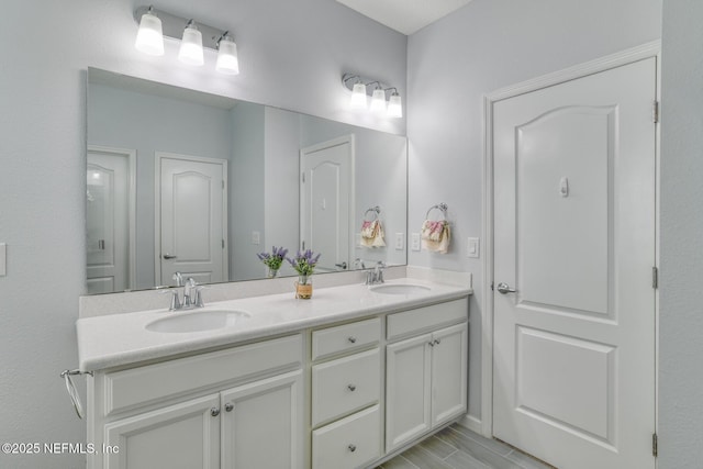 bathroom with a sink and double vanity