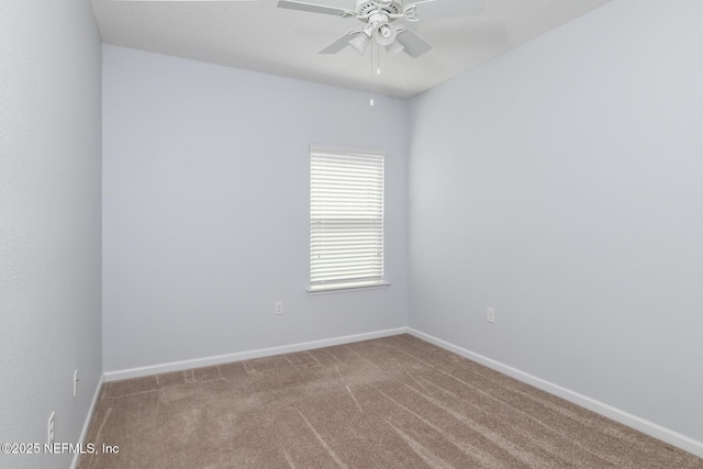 carpeted empty room with baseboards and a ceiling fan