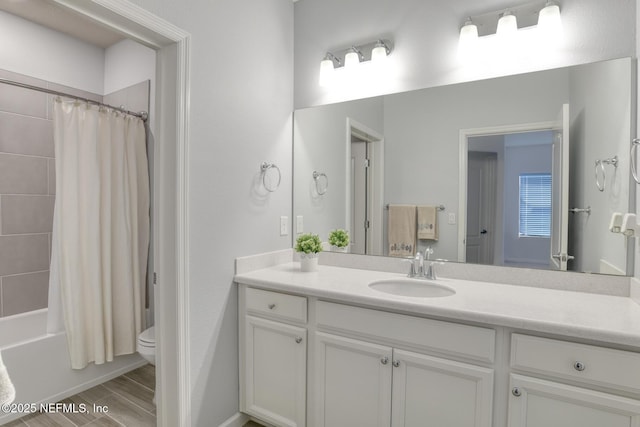 full bath with toilet, shower / tub combo, wood finish floors, and vanity