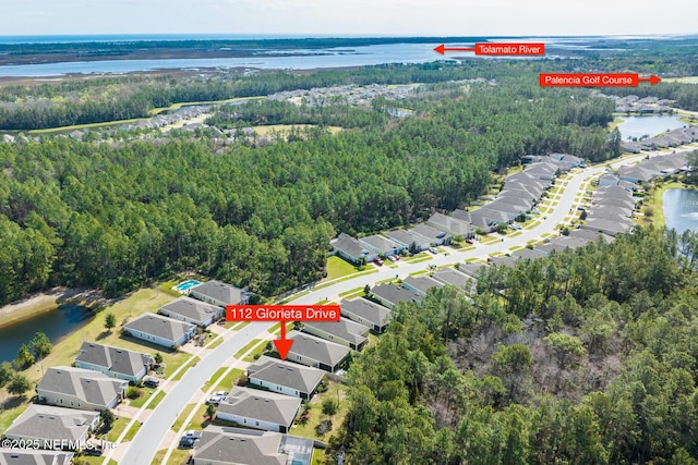 aerial view with a water view, a residential view, and a view of trees