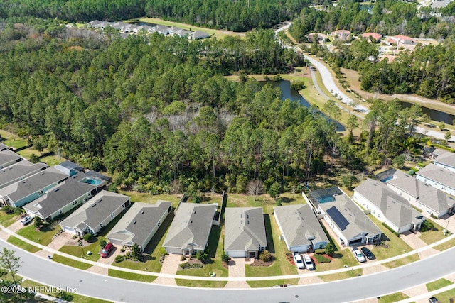 drone / aerial view featuring a residential view and a water view