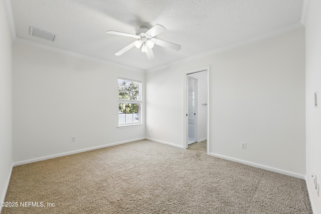 carpeted empty room with a textured ceiling, ceiling fan, baseboards, and ornamental molding