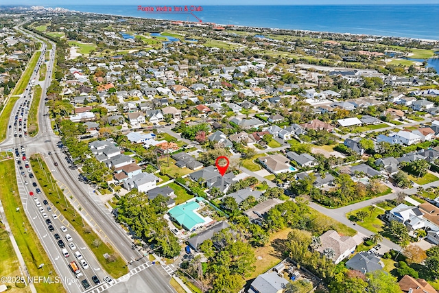 drone / aerial view featuring a residential view and a water view