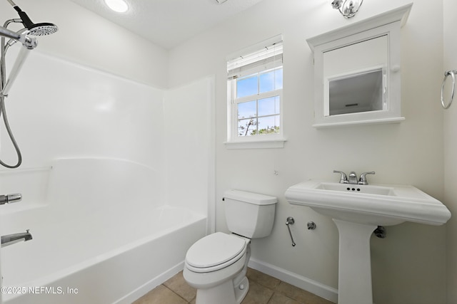 full bathroom featuring baseboards, a sink, tile patterned flooring, toilet, and shower / bathtub combination