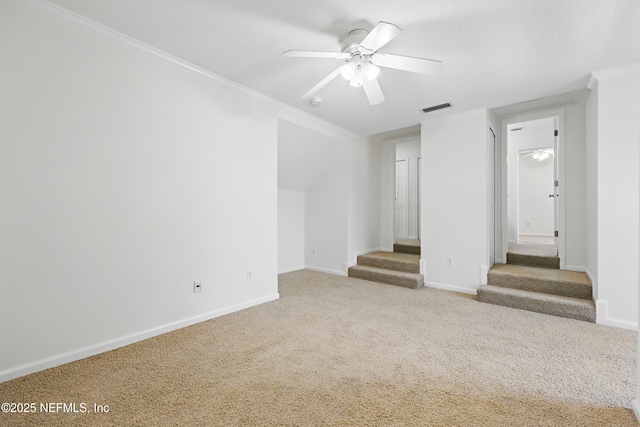 unfurnished living room featuring stairway, a ceiling fan, visible vents, ornamental molding, and carpet flooring