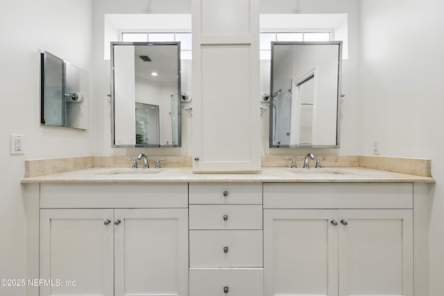 bathroom featuring double vanity, visible vents, and a sink