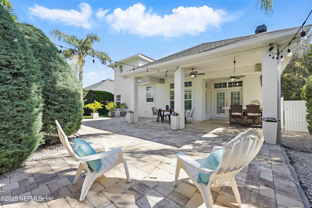 view of patio / terrace featuring french doors, outdoor dining space, a ceiling fan, and fence