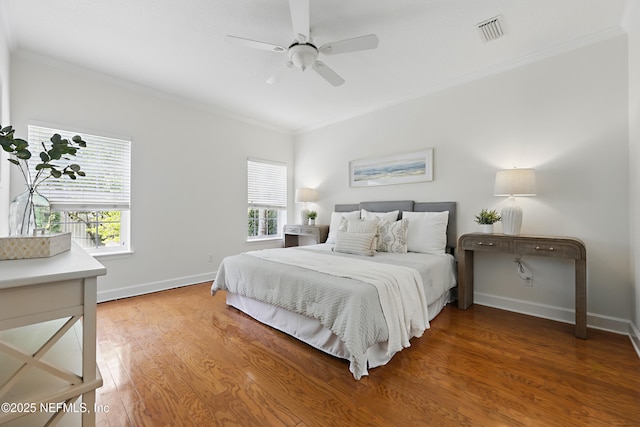 bedroom featuring ornamental molding, baseboards, visible vents, and light wood-type flooring