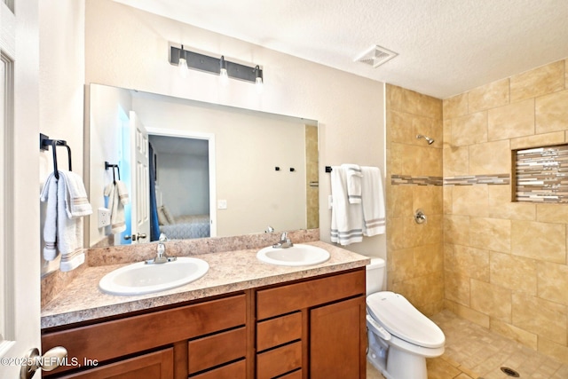 full bathroom featuring double vanity, ensuite bath, visible vents, and a sink