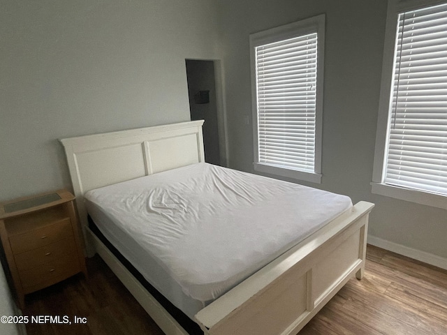 bedroom with baseboards and light wood-type flooring