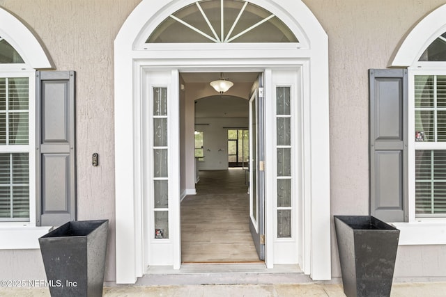 property entrance featuring stucco siding