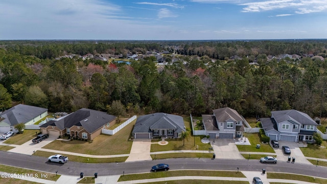 aerial view featuring a forest view and a residential view