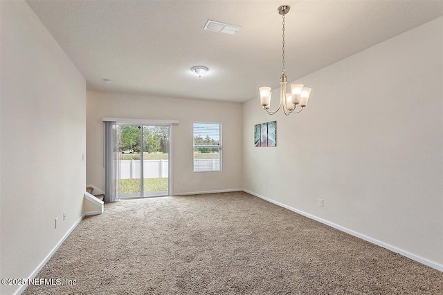 carpeted spare room featuring visible vents, baseboards, stairway, a textured ceiling, and a chandelier