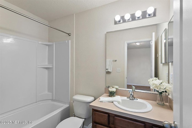 bathroom with a textured wall, toilet, a textured ceiling, vanity, and washtub / shower combination