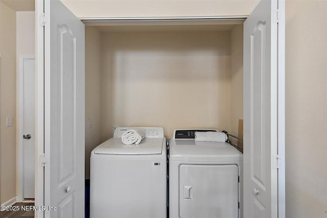 clothes washing area featuring laundry area and washer and clothes dryer