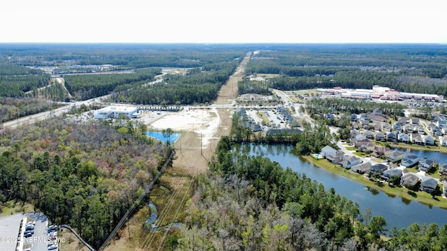 aerial view featuring a water view and a wooded view