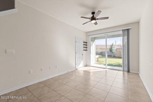 unfurnished room featuring light tile patterned floors, baseboards, and a ceiling fan