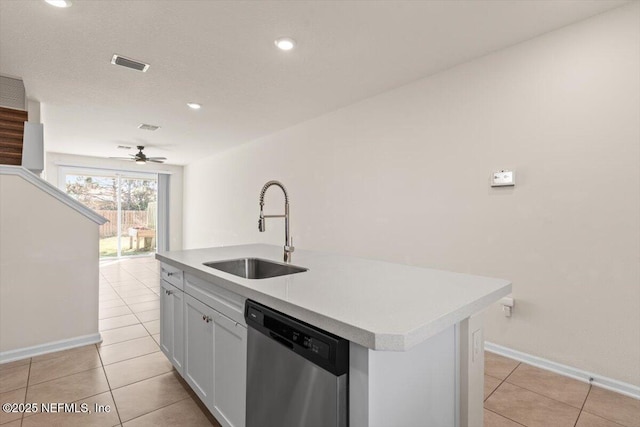 kitchen featuring light countertops, visible vents, a sink, an island with sink, and dishwasher