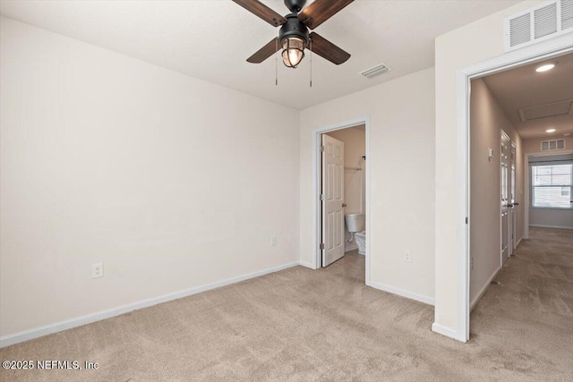 unfurnished bedroom with baseboards, visible vents, and light colored carpet