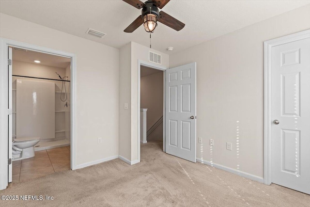 unfurnished bedroom featuring light carpet, baseboards, visible vents, and ensuite bathroom