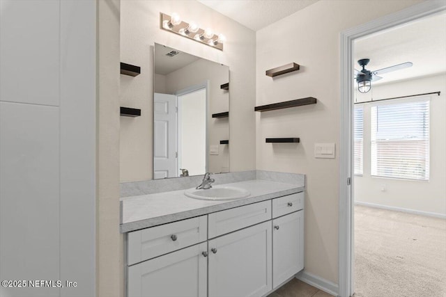 bathroom featuring visible vents, baseboards, and vanity