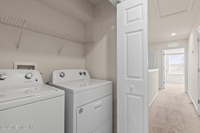 laundry room featuring laundry area, baseboards, separate washer and dryer, and light colored carpet