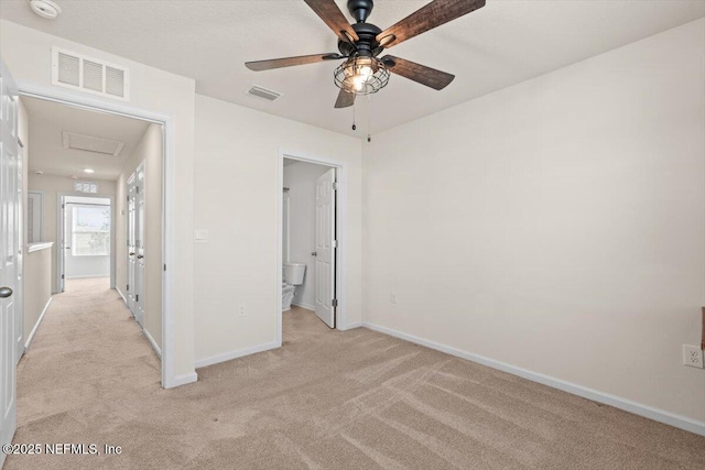 unfurnished bedroom featuring attic access, visible vents, light carpet, and baseboards