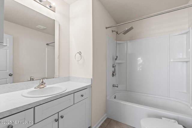 bathroom featuring washtub / shower combination, tile patterned flooring, vanity, and toilet