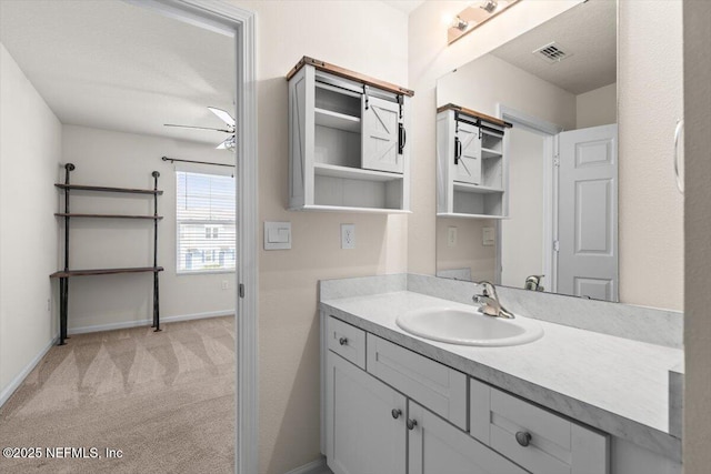 bathroom with baseboards, visible vents, and vanity