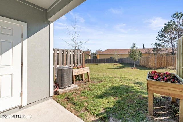 view of yard with central AC unit and a fenced backyard