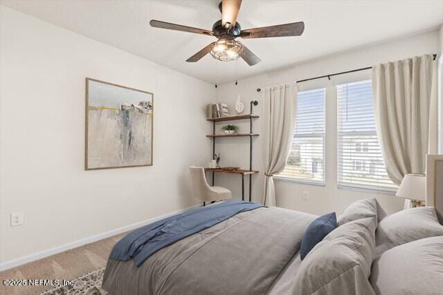 bedroom with carpet floors, a ceiling fan, and baseboards