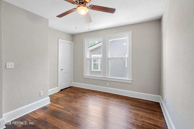 unfurnished room featuring a ceiling fan, wood-type flooring, a textured wall, and baseboards