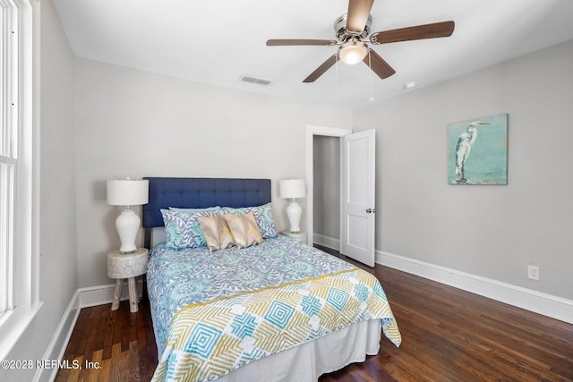 bedroom featuring ceiling fan, wood finished floors, and baseboards