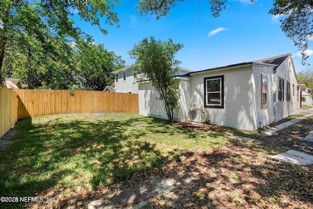 view of yard featuring ac unit and a fenced backyard