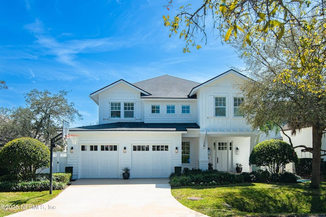 view of front facade with driveway, a garage, a front lawn, and board and batten siding