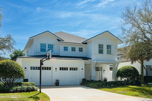 view of front of home with concrete driveway, board and batten siding, and an attached garage