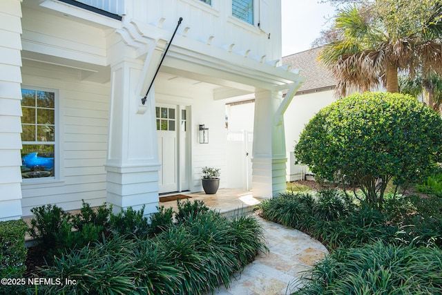 view of exterior entry with a porch