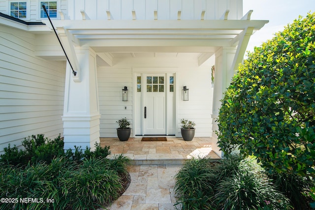 doorway to property featuring board and batten siding