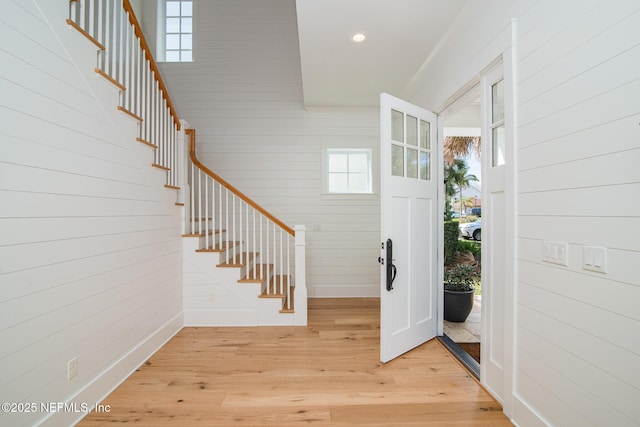 entrance foyer with light wood-style flooring, stairway, and recessed lighting