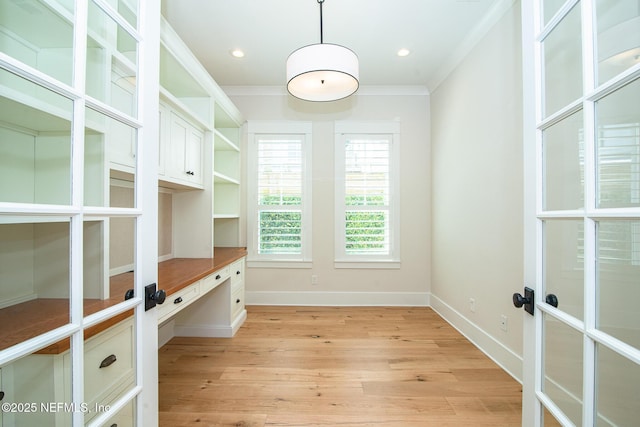 unfurnished office with recessed lighting, light wood-style flooring, crown molding, and french doors