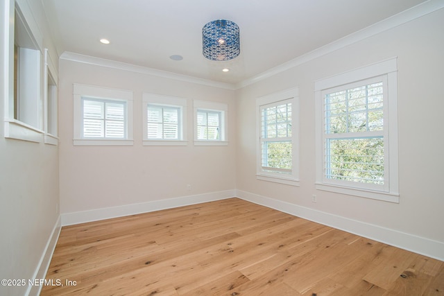 spare room featuring baseboards, light wood finished floors, recessed lighting, and crown molding