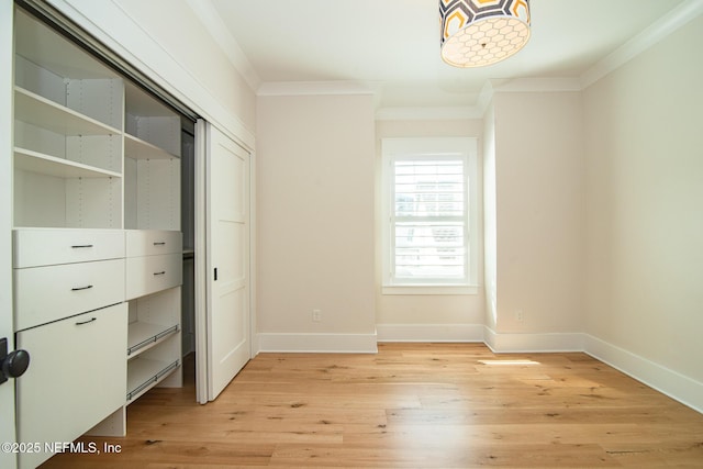 unfurnished bedroom with light wood-type flooring, baseboards, and ornamental molding