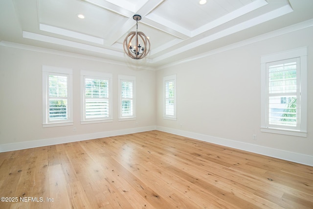 unfurnished room featuring a healthy amount of sunlight, coffered ceiling, light wood finished floors, and baseboards