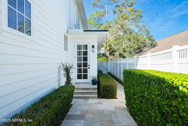 entrance to property featuring fence