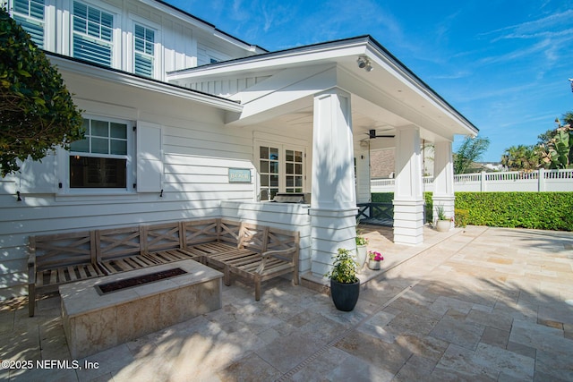 view of patio with ceiling fan and fence