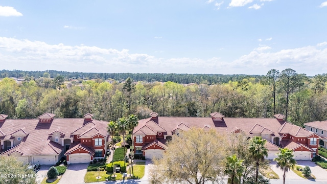 aerial view featuring a forest view and a residential view