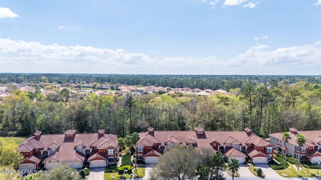 birds eye view of property featuring a residential view and a wooded view