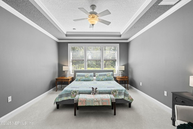 bedroom with a tray ceiling, carpet flooring, and crown molding