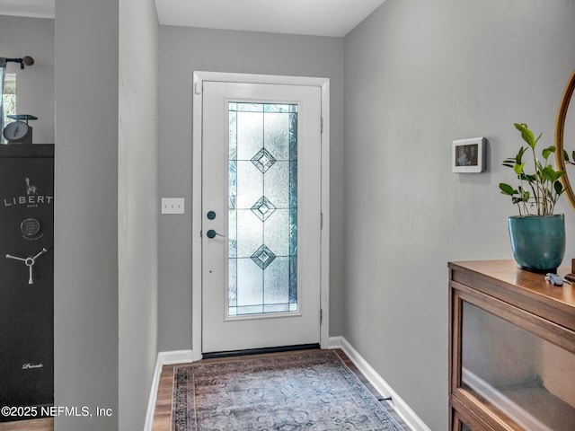 entrance foyer featuring baseboards and wood finished floors