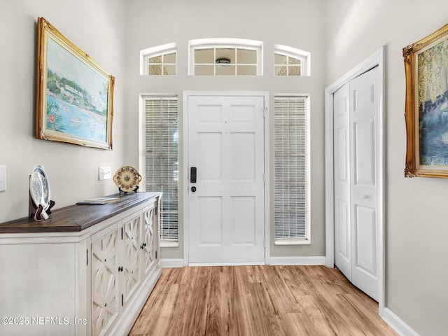 entrance foyer with light wood-type flooring and baseboards